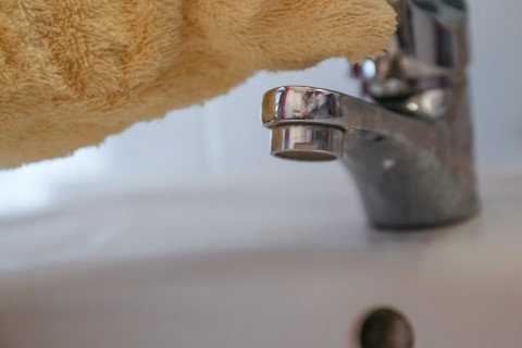 a tap being cleaned
